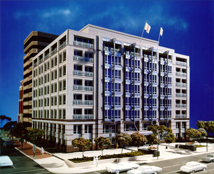 Detailed scale model of the American Chemical Society building, with trees, cars, and pedestrians